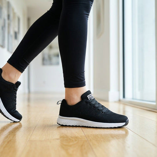 The Long Shift Sneakers — Black, walking on a hard floor