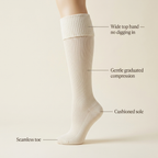 Wide top band, gentle graduated compression, cushioned sole, seamless toe