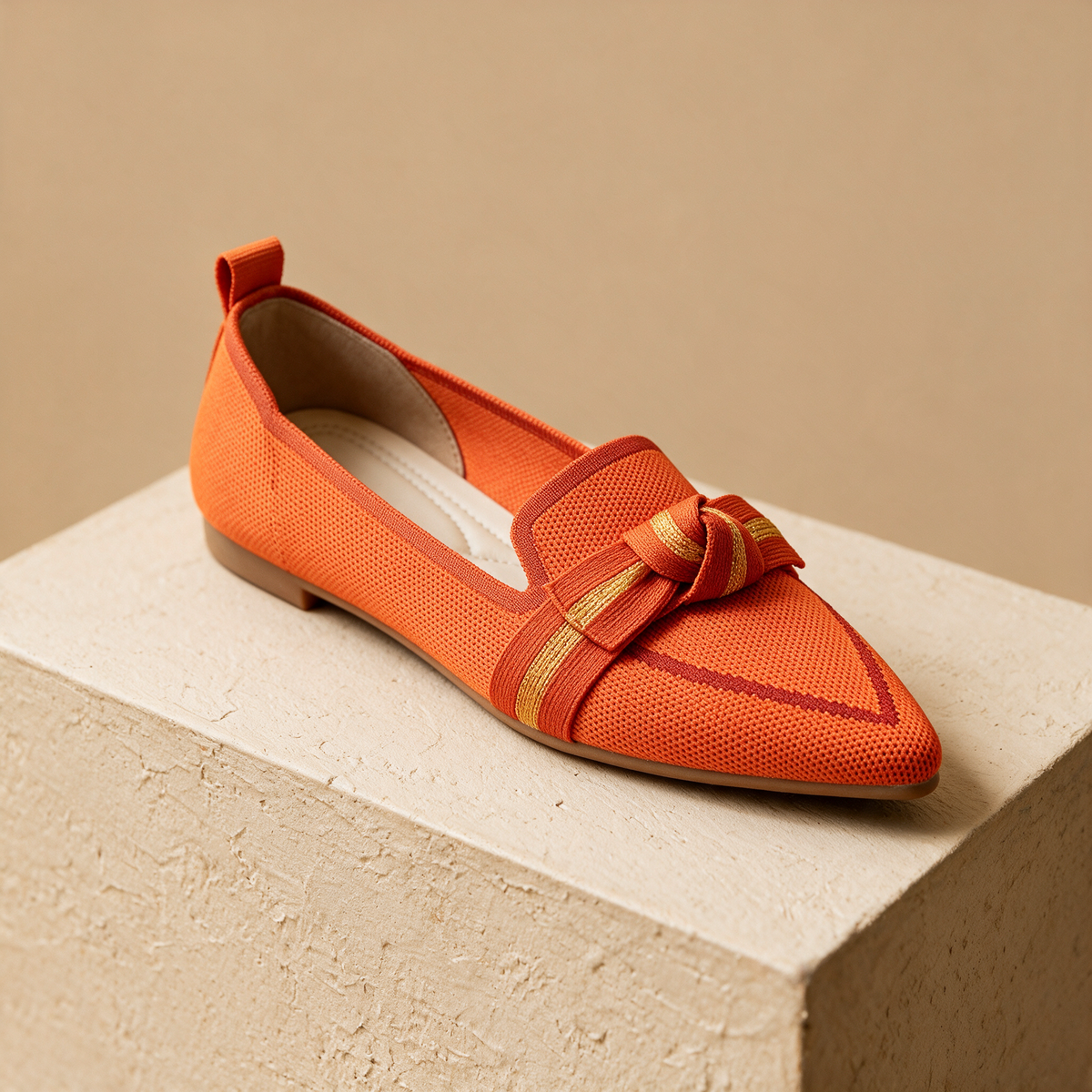 The Long Weekend Loafers in Terracotta — vivid orange knit, tonal striped bow