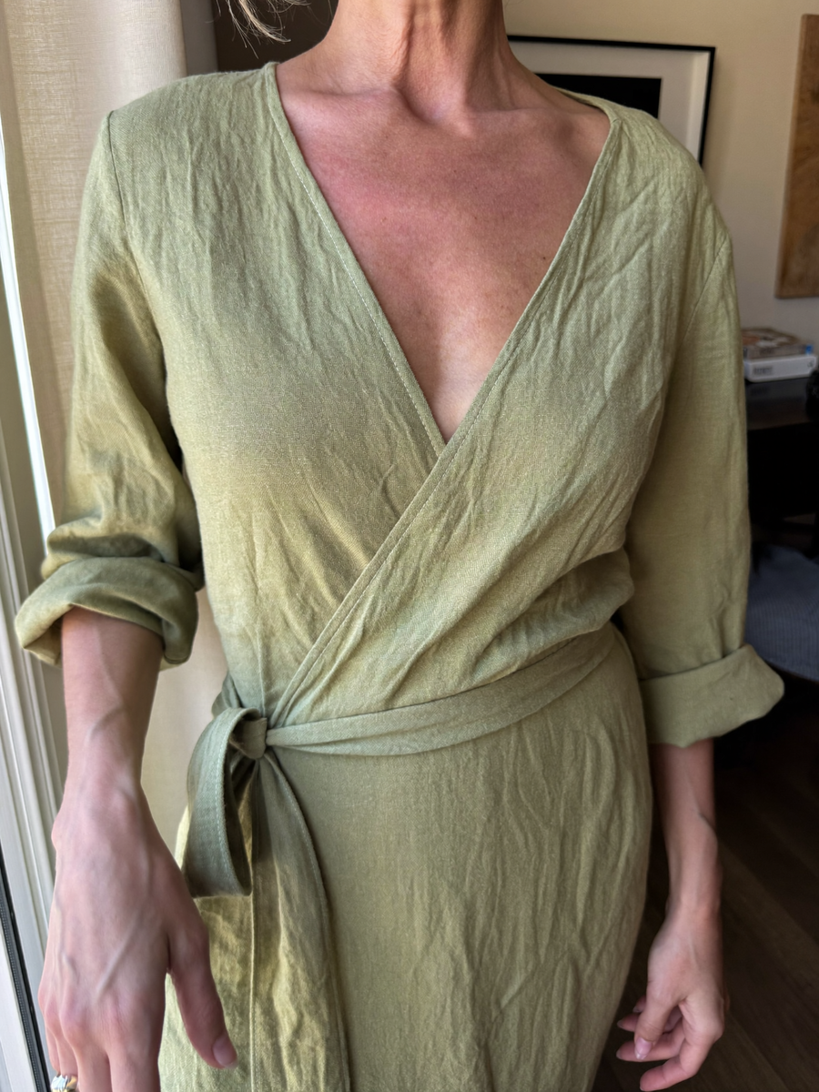 The Verona Wrap Dress in Sage, worn at home